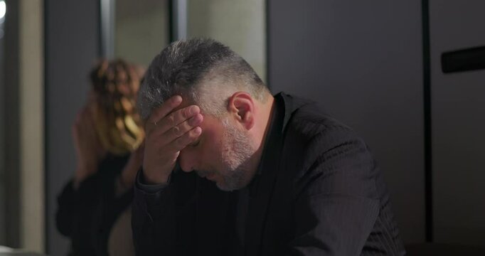 Female manager reprimands male employee in front of coworkers during intense office meeting, exposing workplace power dynamics and professional embarrassment