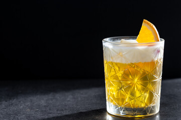 Classic cocktail whiskey sour on black background. Copy space