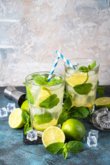 Mojito with rum and lime on black background.