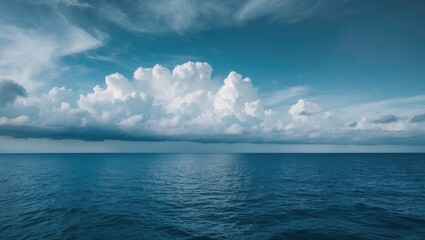 Obraz premium Vast ocean view with a partly cloudy sky, serene water surface, and horizon line, capturing the calmness of the sea and the beauty of nature.