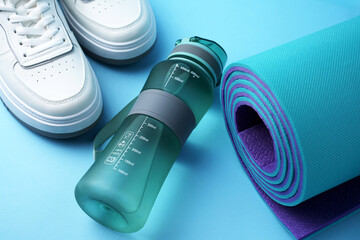 Fitness gear including a sports water bottle, running sneakers, and an exercise mat