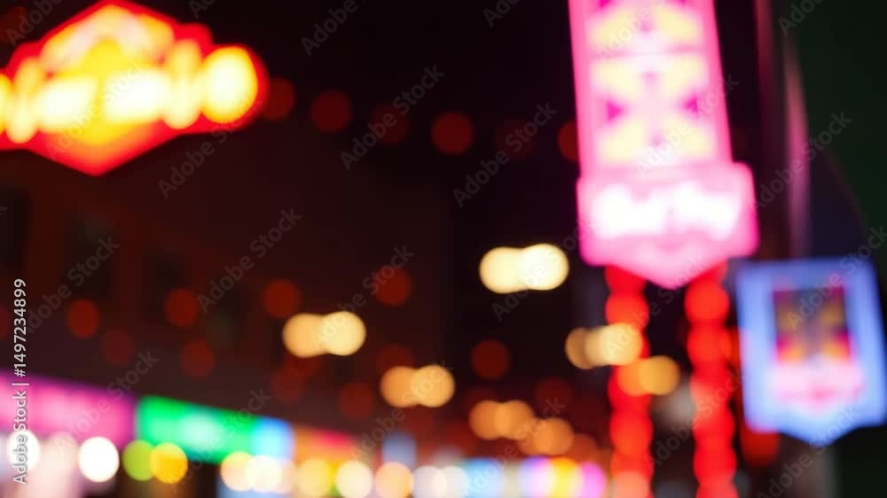 Poster a video showing vibrant blurred lights shining in darkness creating an abstract and colorful spectac