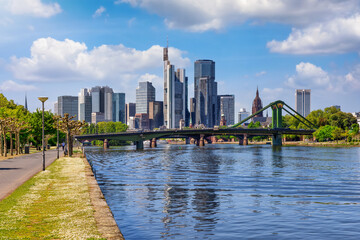 The riverbank of the Main river with view of the skyline of the City of Frankfurt, Germany, during a sunny spring day