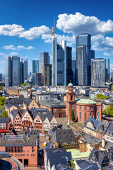 Elevated view of the old town Roemer in Frankfurt, Germany, with the financial office skyscraper skyline right behind it on a sunny day
