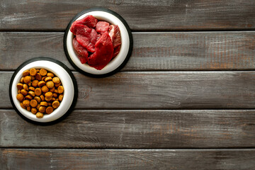 Various pet food in feeding bowls. Natural and dry food for choice. Top view