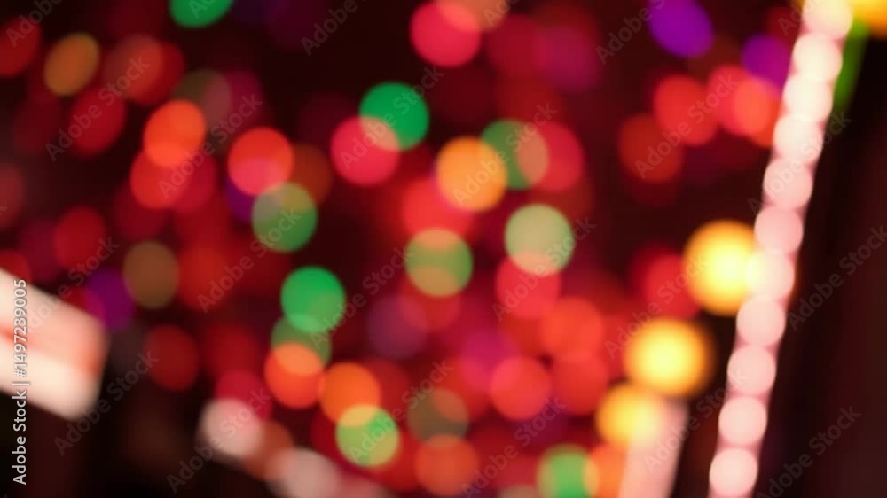 Poster a video showing vibrant blurred lights shining in darkness creating an abstract and colorful spectac