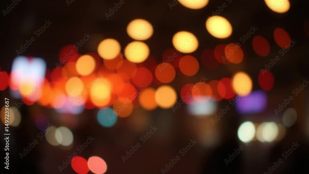 Poster a video showing vibrant blurred lights shining in darkness creating an abstract and colorful spectac