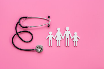Fototapeta premium Family wooden figure with parents and children and medical stethoscope. Family medicine, medical and social insurance concept