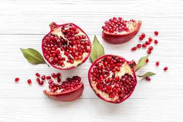 Top view of fresh ripe pomegranate with half and pieces ready for eating