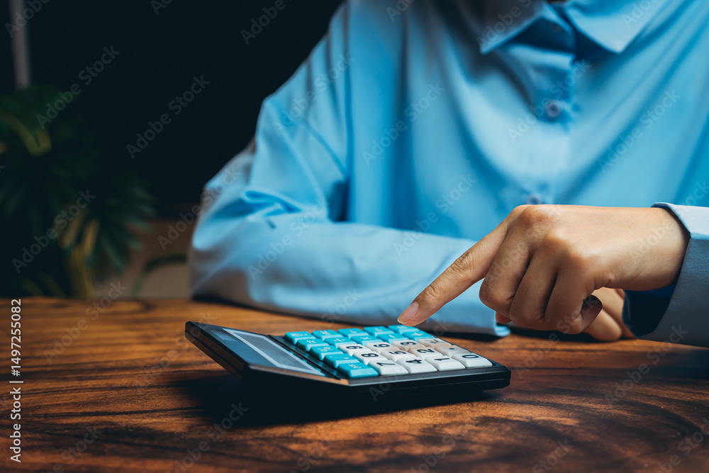 Poster business professional using calculator for financial calculations in modern workspace setting