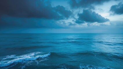 Fototapeta premium A vast ocean under a stormy sky with dark clouds and turbulent waters.