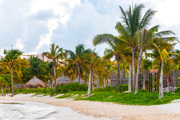 Tropical Caribbean beach people parasols fun Playa del Carmen Mexico.