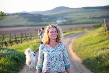 woman walking in vineyard at sunset
