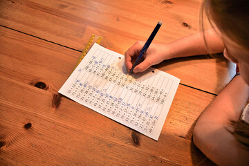 Obraz premium Girl doing homework from math