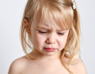 Portrait of a crying Caucasian girl on white background