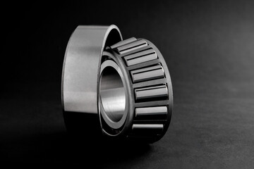 roller bearings on a black background, blank for creativity. Parts for machines and mechanisms in rotation units. Close-up  focus copy space