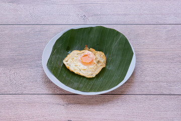 Fried eggs on a banana leaf