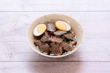 Chinese roll noodle soup with crispy pork