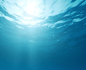 A tranquil underwater scene in soft blue hues with sunbeams filtering down from the surface