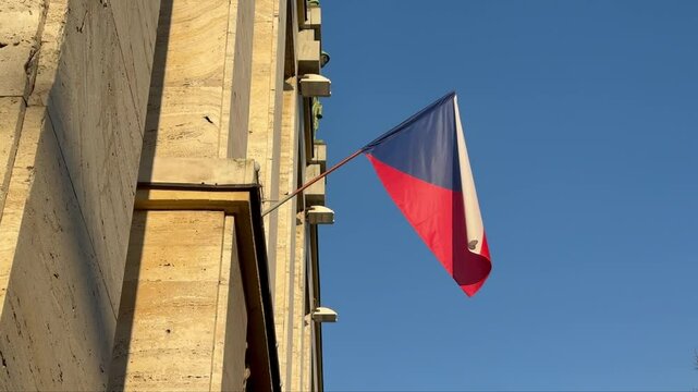 Czech flag waving on building at sunset