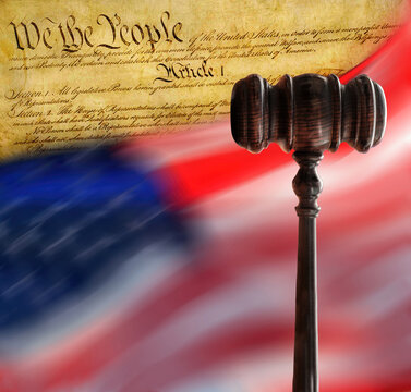 American flag flying with Declaration of Independence and gavel