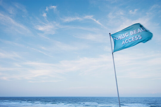 Blue Public Beach flag against sky at Topsail Beach