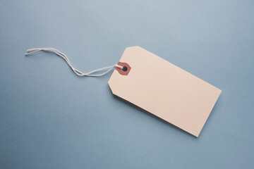 Studio shot of blank hang tag on blue background