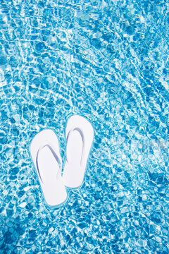 Flip Flops floating on swimming pool water surface