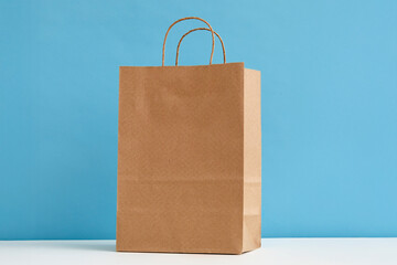 Studio shot of paper shopping bag on blue background