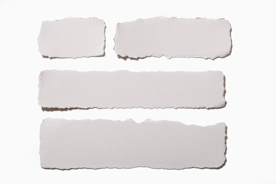 Torn white paper on white background