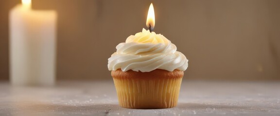 Perfectly frosted vanilla cupcake with a lit candle ,  candlelight,  dessert