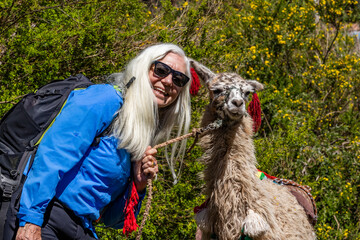 Portrait of smiling woman posing with llama