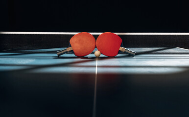 Horizontal photo. Two rackets and ball on the tennis table