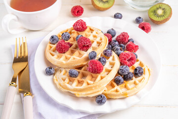 Sweet breakfast belgian waffles with fruit berry