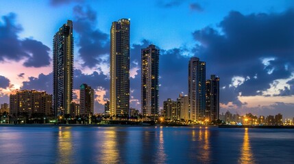 Naklejka premium Coastal Cityscape at Dusk: Stunning Skyscrapers Reflected in Calm Waters