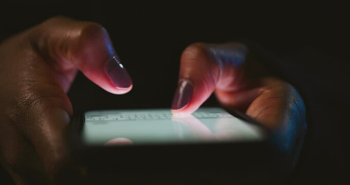 Night, cybersecurity and hands typing with phone for texting, internet troll or person cyberbullying. Dark comment, social media netizen or keyboard warrior for smartphone, online bullying or hacking