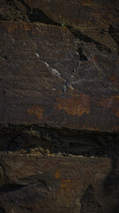 A textured stone background with a brutal, monolithic rock formation, cracks, and fragments. Perfect for design templates or banners, showcasing raw power and natural beauty.