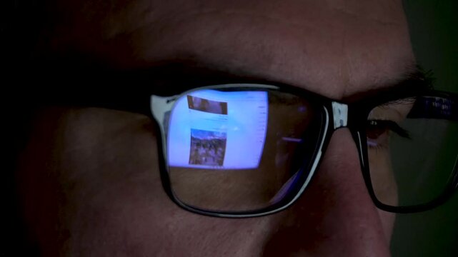 Screen Reflection on Glasses, Guy Working on Computer, Close up Shot