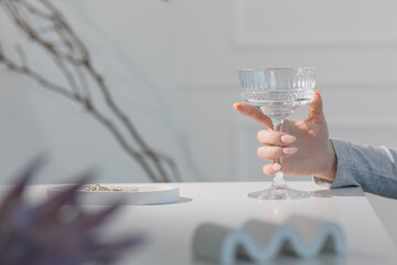 Stylish manicured hand holding water glass, luxury summer wellness and healthy hydration concept