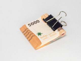 Indonesian Rupiah Banknotes Stacked and Clipped on a White Background