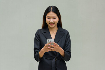 Happy business woman texting with mobile phone