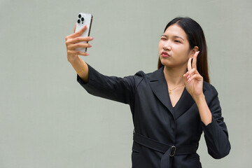 businesswoman with mobile phone taking selfie