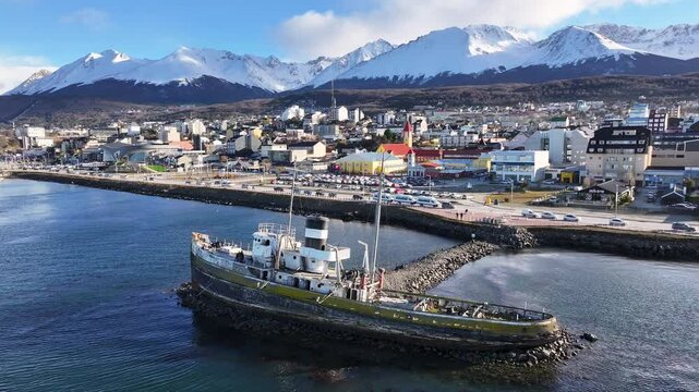 Saint Christopher Boat In Ushuaia Tierra Del Fuego Argentina. Aerial View Of A Bustling City With High-Rise Buildings And Traffic. Nature Travel Destination Snow Covered Forest Trees.