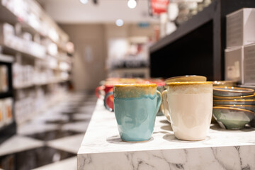 Porcelain coffee cups on display for sale on the shop counter.