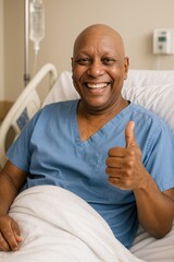 Smiling man in hospital bed giving thumbs up in blue scrubs