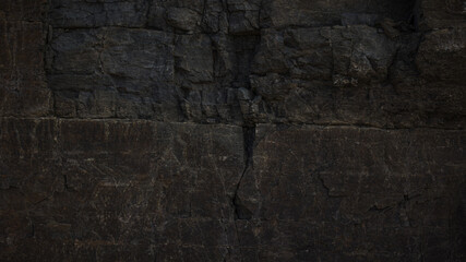 A textured stone background showcasing a brutal, monolithic rock formation with cracks and fragments. Perfect for design templates, banners, or projects highlighting natural power and beauty.