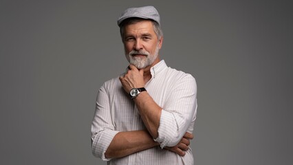 Smiling man wearing white shirt and flat cap, close-up