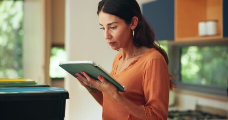 Tablet, recycling and woman in kitchen in home for sorting trash, cleaning or housekeeping. Bins, digital technology and female person organize dirt in containers for social responsibility or hygiene
