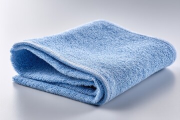 Close-up studio shot of a neatly folded, light blue terry cloth towel, perfect for cleaning, drying, or household chores, set against a clean white background.
