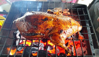 Smoky Delight: Perfectly Grilled Whole Duck over Glowing Charcoal Embers ready to eat